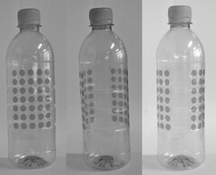 Position mark; the mark consists of a dot pattern on a bottle; the dot pattern consists of two rectangular matrices, each comprising 7x5 dots, positioned vertically and on opposite faces on the body of a bottle.